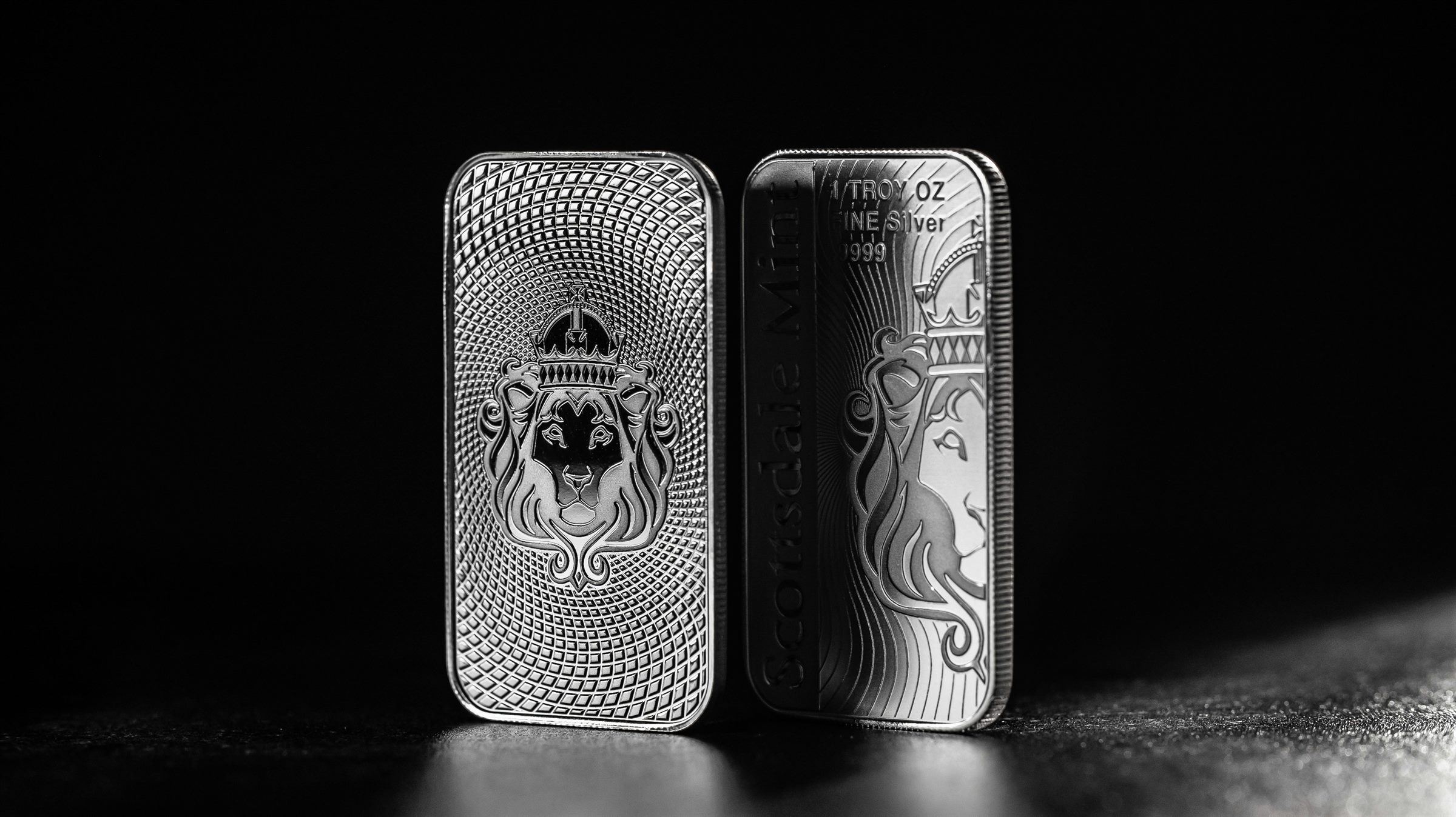 Two .999 fine silver bars in dramatic light.